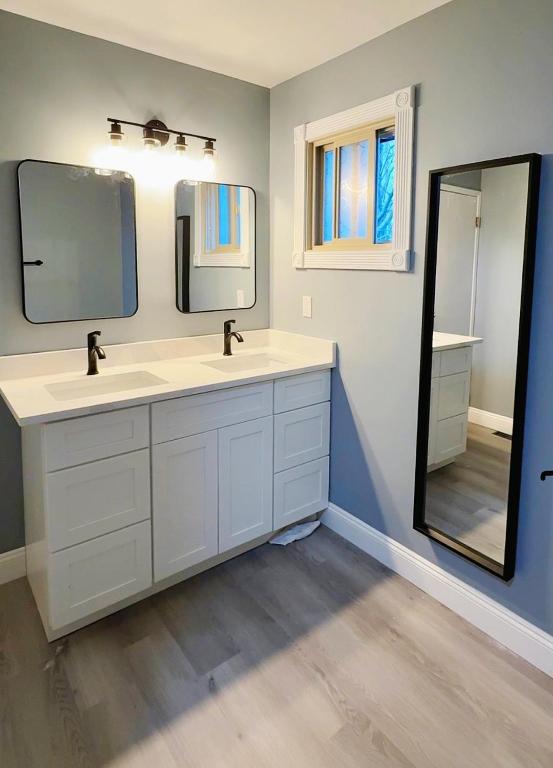 a bathroom with two sinks and a large mirror at Gorgeous House&30 second Bus station Close C-Train& Free Parking in Calgary