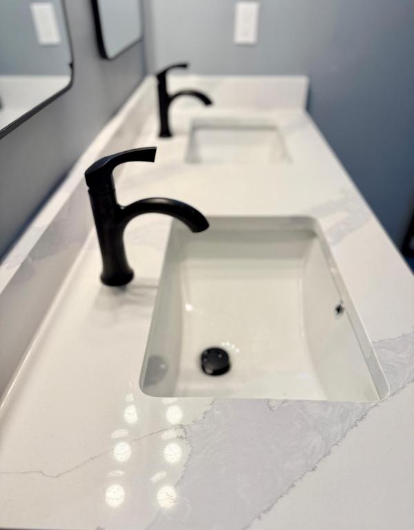 a white sink with a faucet on a counter at Gorgeous House&30 second Bus station Close C-Train& Free Parking in Calgary