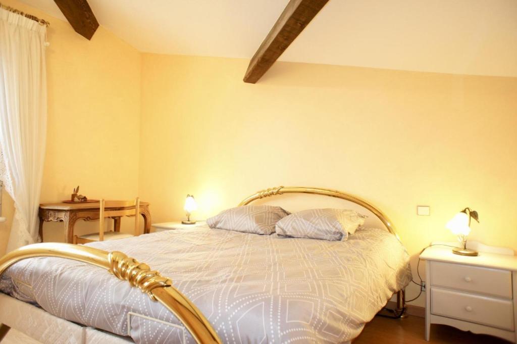 a bedroom with a bed with two pillows on it at I Melograni 8 personnes in Chomérac