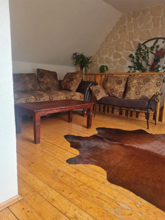 a living room with couches and a wooden floor at Villa Dany in Klagenfurt