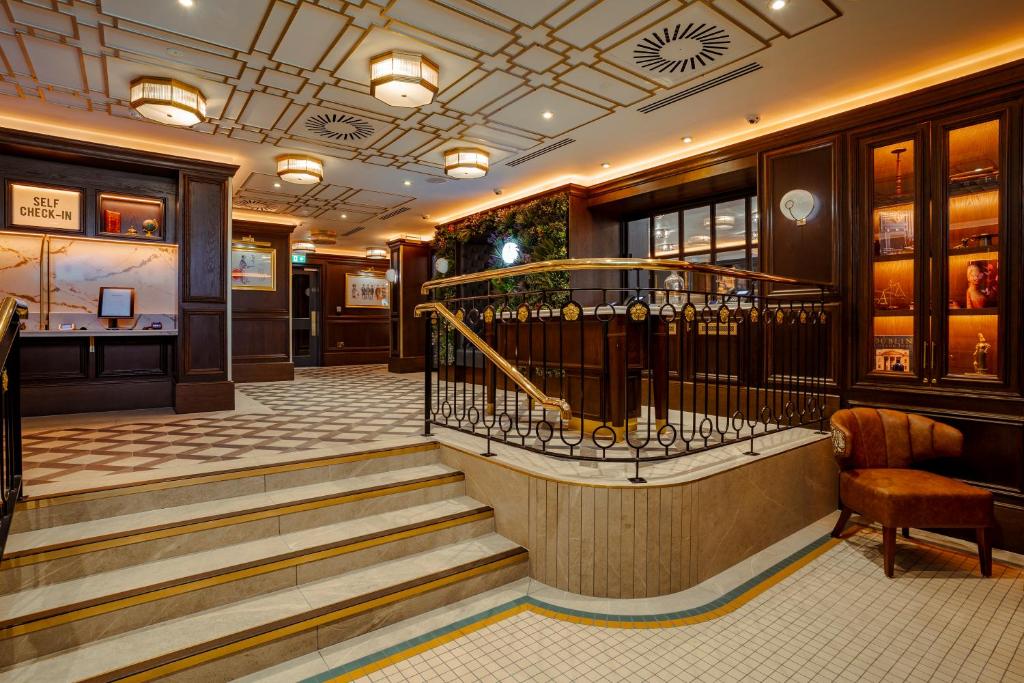 a restaurant lobby with stairs and a bar at The Mercantile Hotel in Dublin