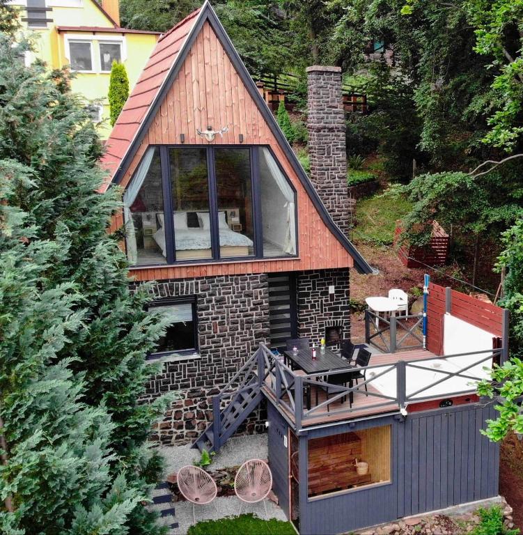 a small house with a deck and a patio at Altitude Matra in Mátraszentimre