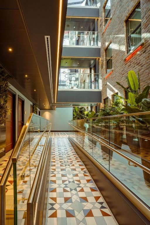 a hallway in a building with a checkered floor at The Mercantile Hotel in Dublin
