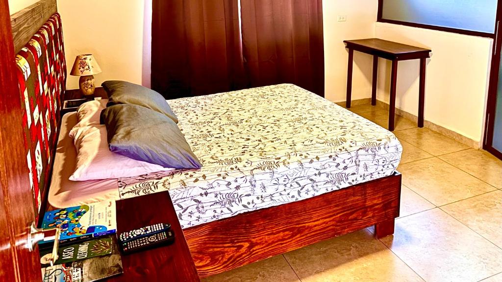 a bedroom with a wooden bed with at La Serrania B&B in Boquete