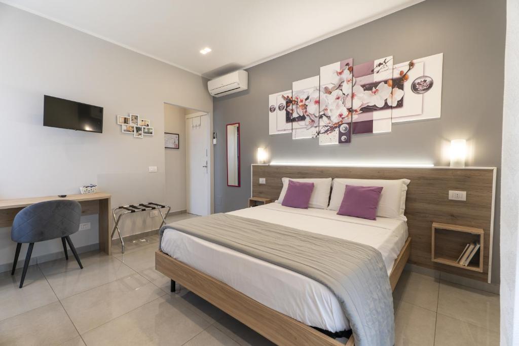A bed or beds in a room at Affittacamere Orchidea for Tourists Hesperia Hosp