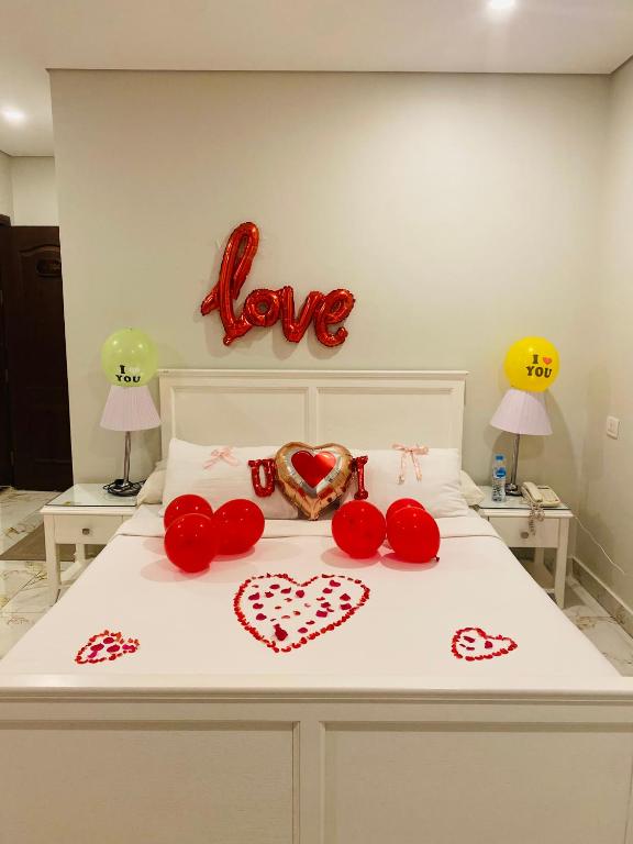 a bedroom with a bed with hearts on it at Tiba Rose hurghada in Hurghada