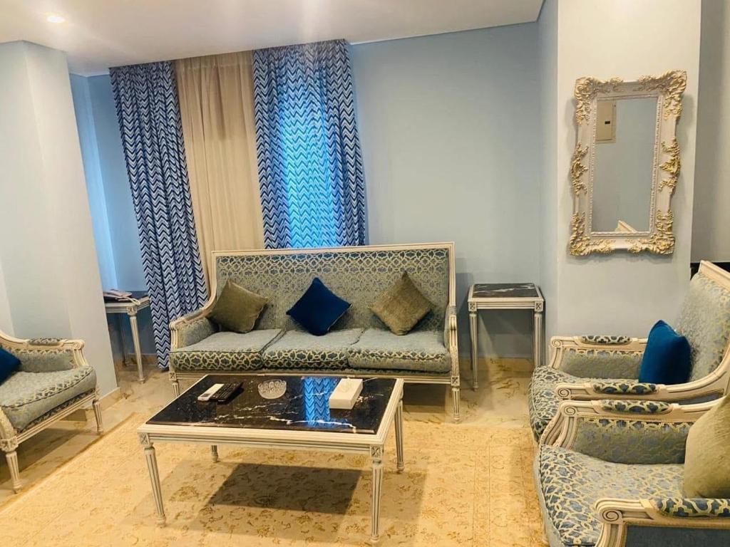 a living room with a couch and a mirror at Tiba Rose hurghada in Hurghada