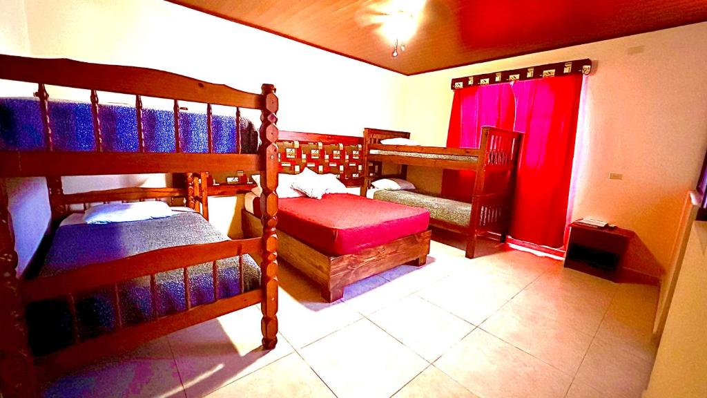 a room with three bunk beds in a house at La Serrania B&B in Boquete