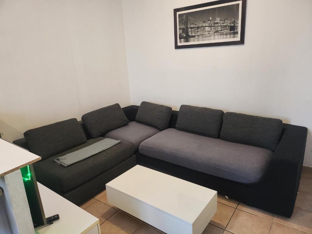 a living room with a couch and a table at Pratique in Sète