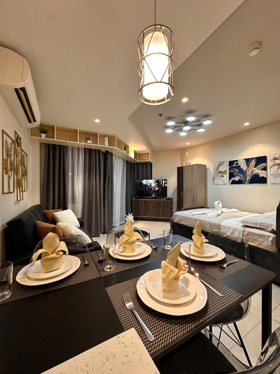 a living room with a table with dishes on it at Tambuli Blue Premium Seaview in Lapu Lapu City