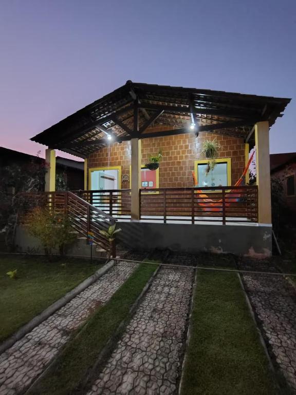a brick house with a porch and a patio at Aconchegante Casa em Gravatá in Gravatá