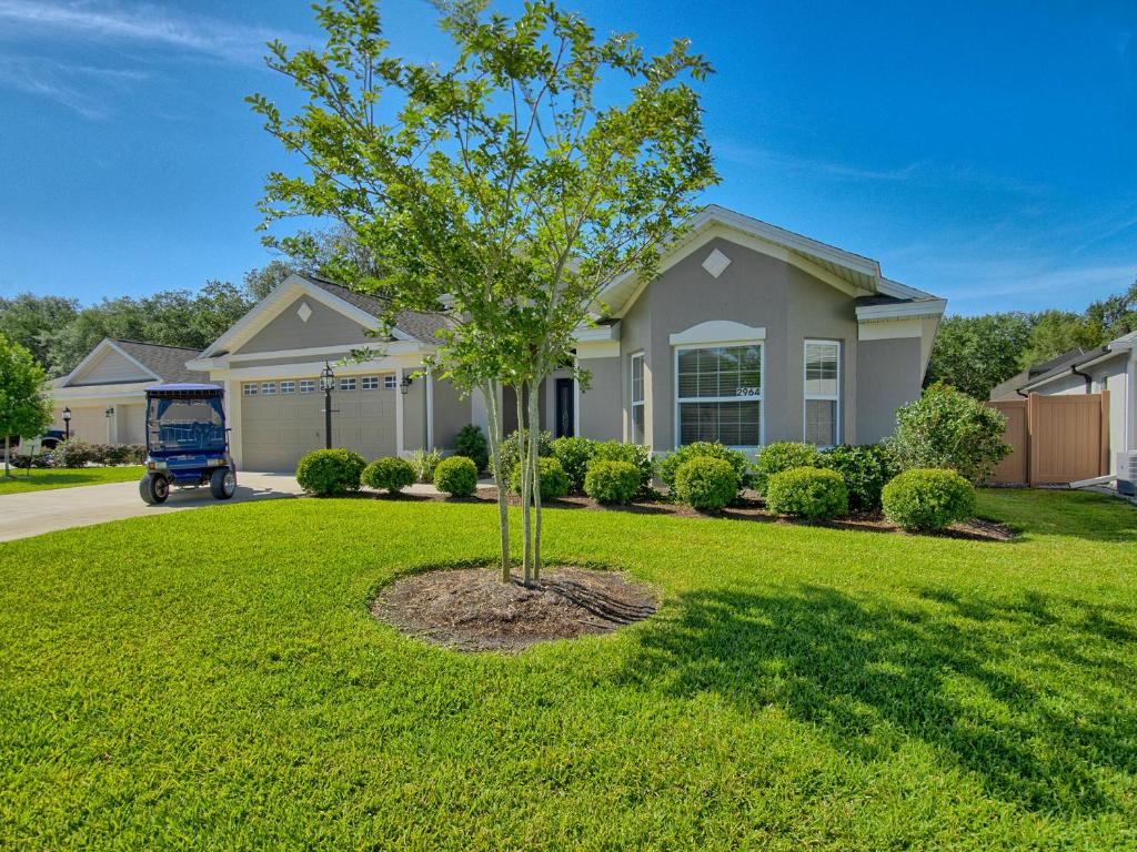 a tree in the front yard of a house at 2964 Z6 VILLAGE OF FENNEY by REMAX Premier in The Villages