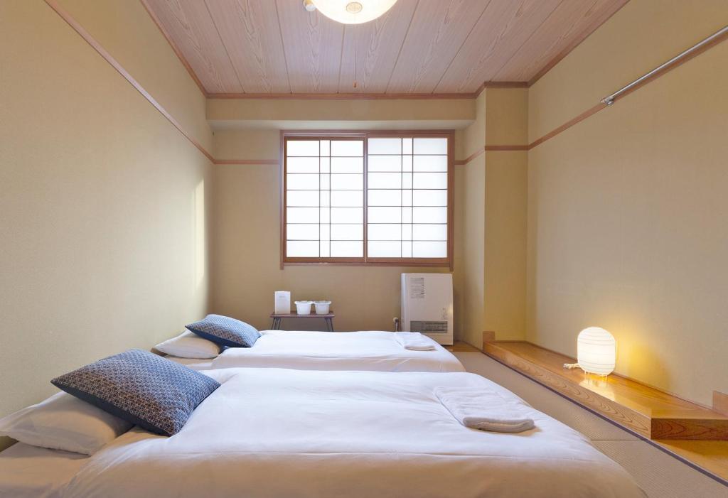Postel nebo postele na pokoji v ubytování Nozawa Peaks