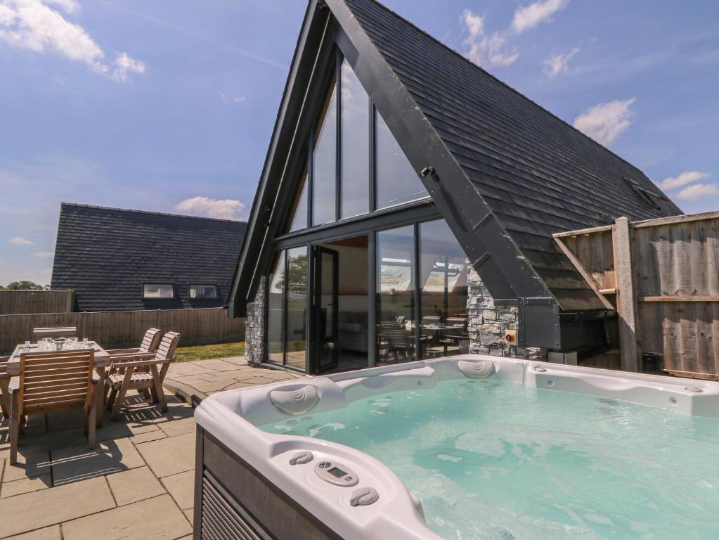 a large jacuzzi tub on a patio at Hill Radnor - The Sheepfold in Llandrindod Wells