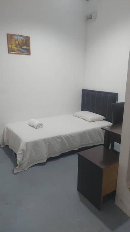 Postel nebo postele na pokoji v ubytování Pandan Hotel
