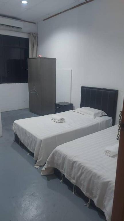 Postel nebo postele na pokoji v ubytování Pandan Hotel