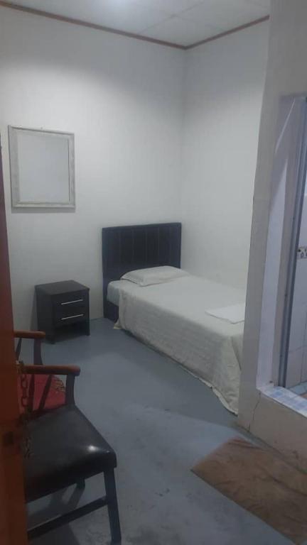 Postel nebo postele na pokoji v ubytování Pandan Hotel