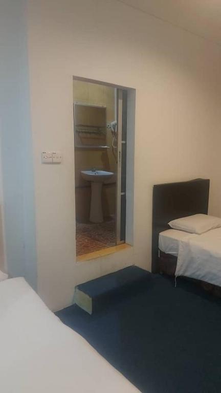 Postel nebo postele na pokoji v ubytování Pandan Hotel