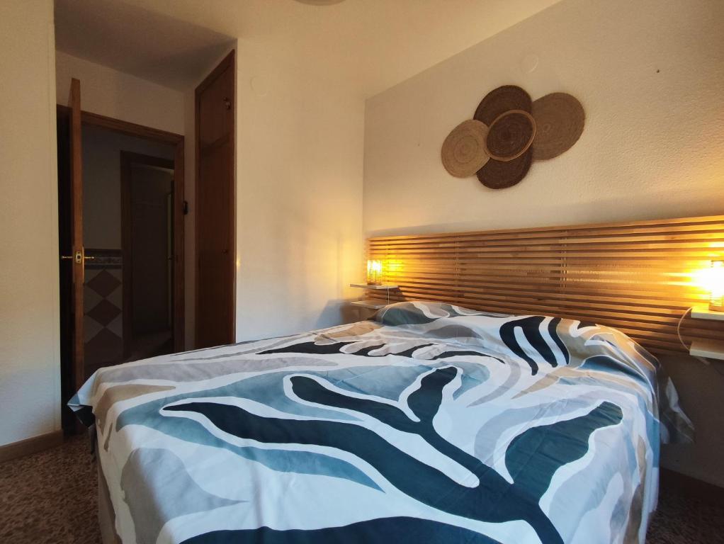 a bedroom with a bed with a hat on the wall at Gran piso cerca del mar in Puerto de Gandía