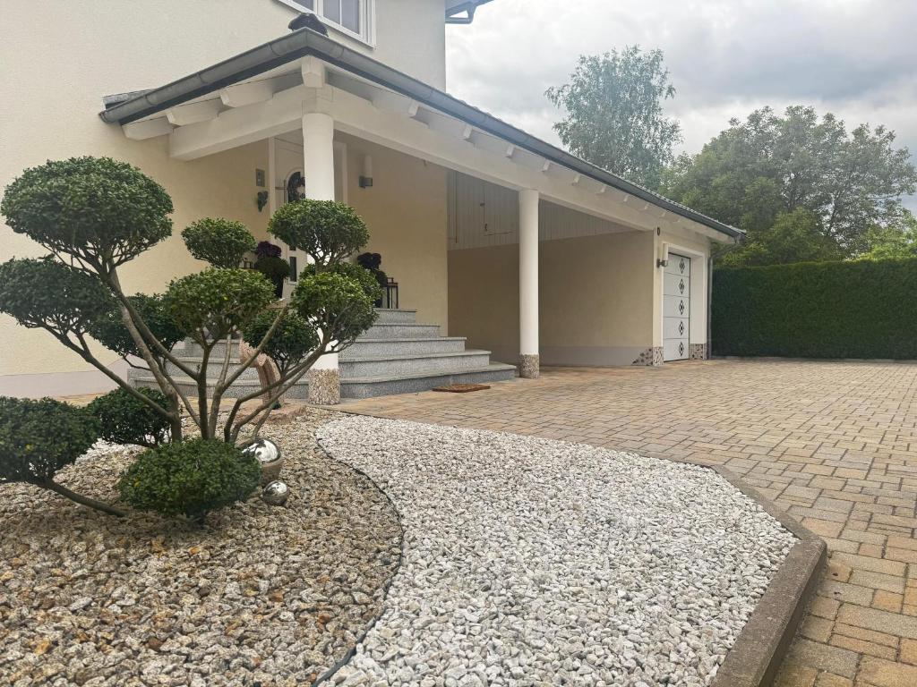 a house with a porch and a brick driveway at Villa Toscana Untersteinach in Untersteinach