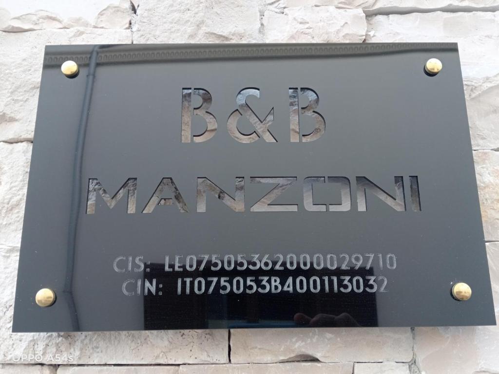 a sign for a manzos sign on a building at B&B Manzoni 2 in Neviano