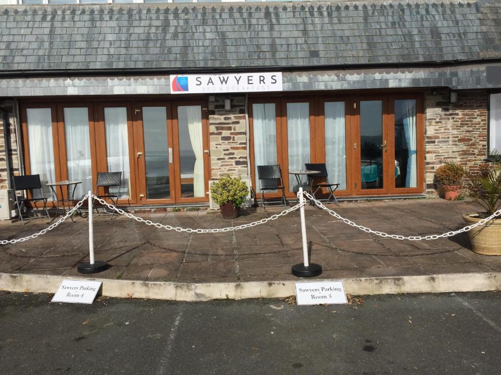 a building with a chain fence in front of it at Sawyers Bed and Breakfast in Looe