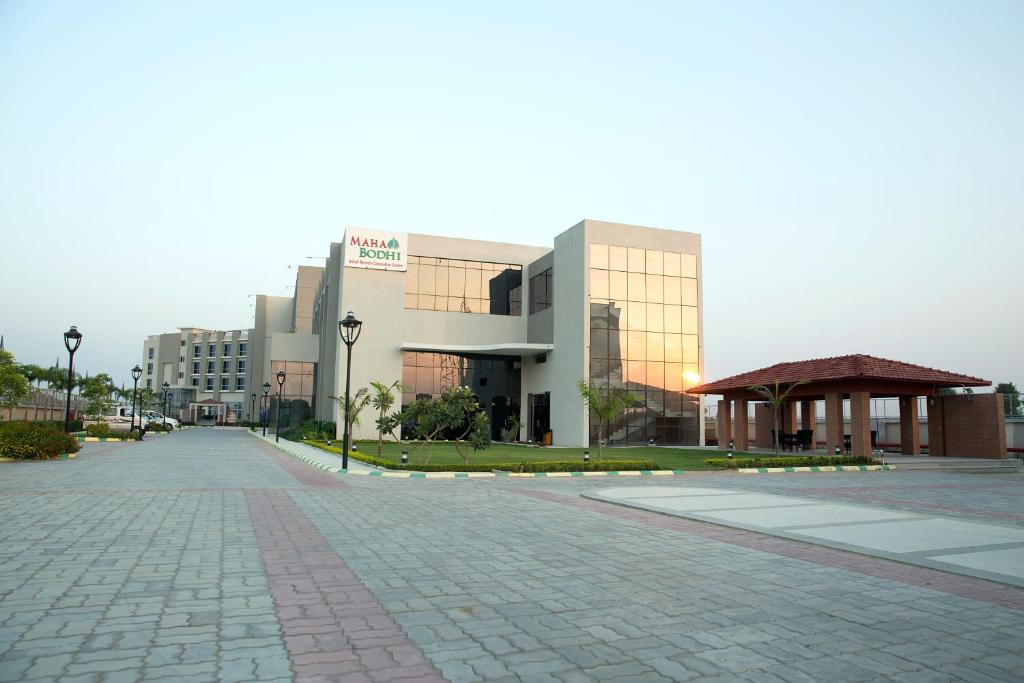 an empty street in front of a building at Maha Bodhi Hotel.Resort.Convention Centre in Bodh Gaya