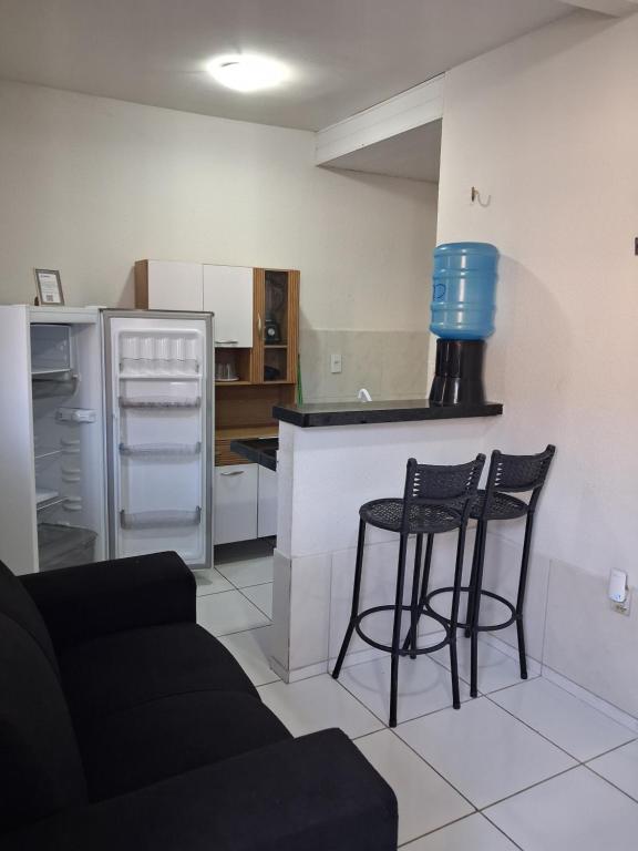 a kitchen with two chairs and a counter in a kitchen at Apartamento Premium Grand Luxo in Fortaleza