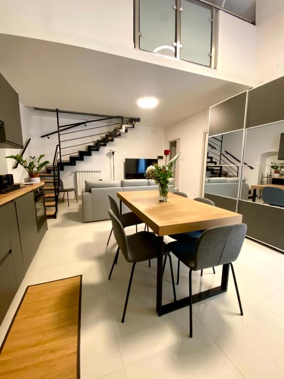 a kitchen and living room with a table and chairs at Casa Angelina in Molfetta