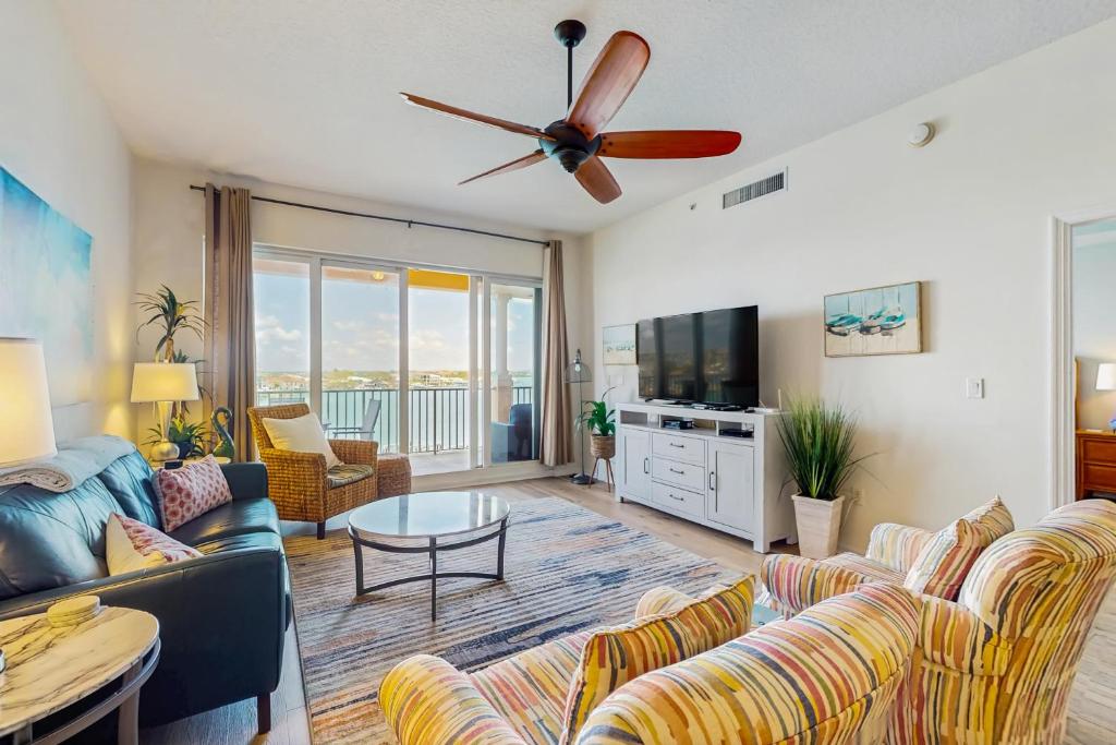 a living room with a couch and a tv at Harborview Grande 402 in Clearwater Beach