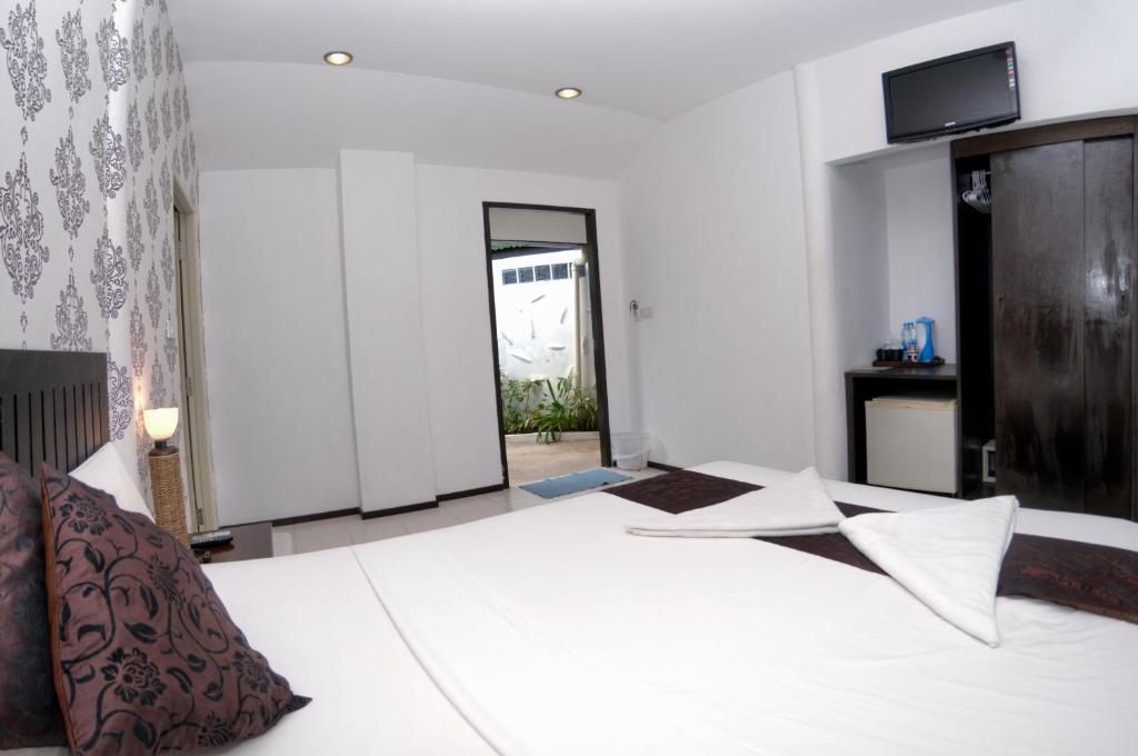 Postel nebo postele na pokoji v ubytování Samui Pier Beach Front & Resort