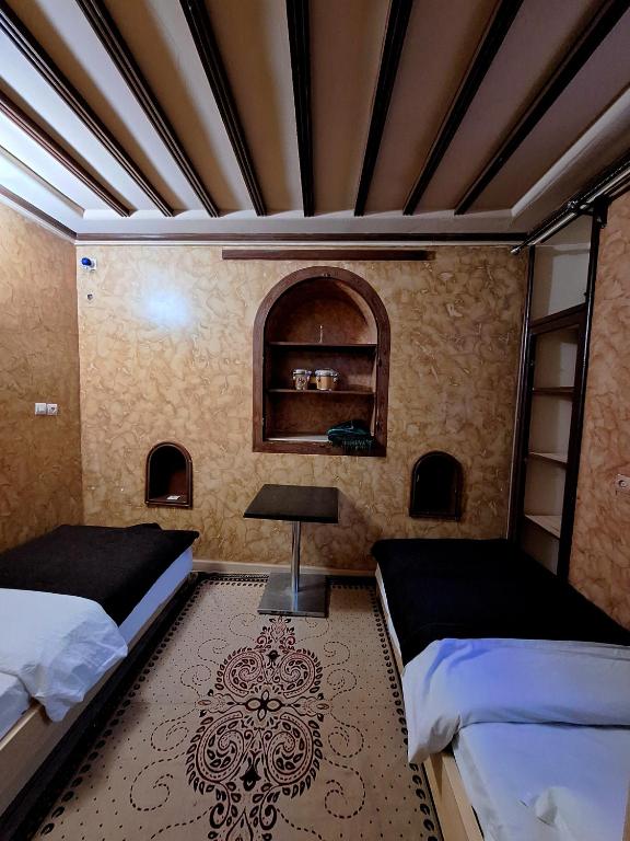 Postel nebo postele na pokoji v ubytování Riad IZRAREN in FIGUIG