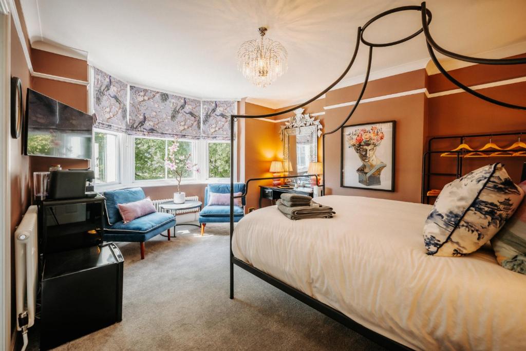 a bedroom with a large bed and a chair at Unique Shrewsbury Rooms in Shrewsbury