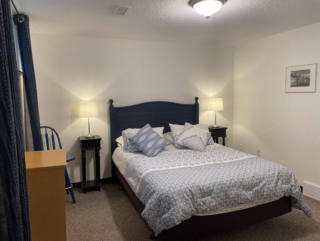 a bedroom with a bed with two tables and two lamps at Entire Apartment in Guelph