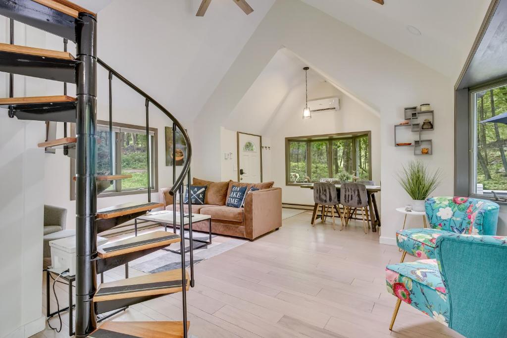 a living room with a staircase and chairs at South Salem Vacation Rental with Furnished Deck! in South Salem