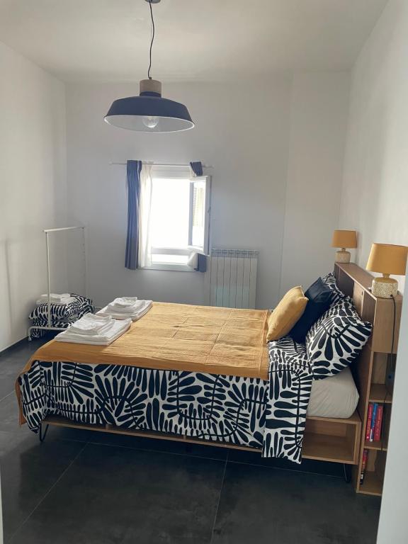 a bedroom with a large bed with a blanket at Casa Luna 23 in Monopoli