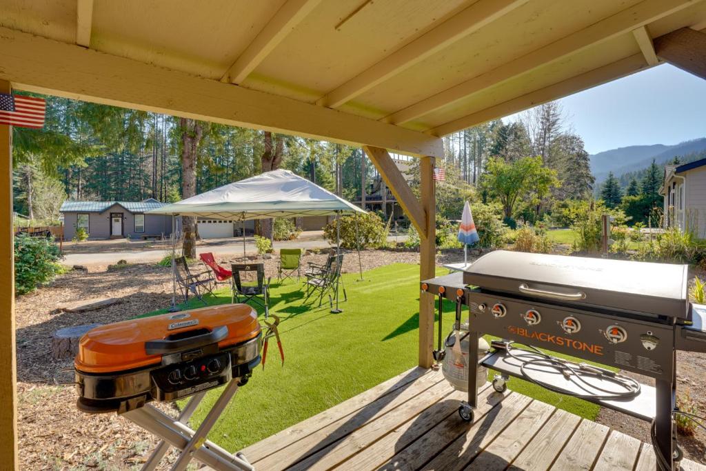 a grill on a wooden deck with a backyard at Lovely Detroit Home with Deck - Walk to Town! in Detroit