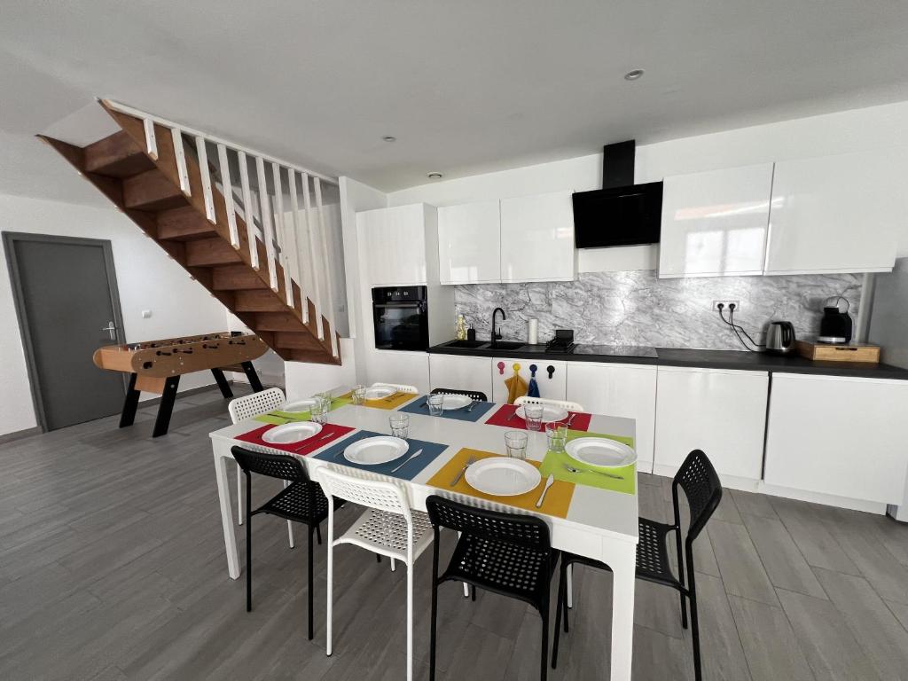 a kitchen with a table and chairs in a room at ValenStay - Maison groupes ou famille - Netflix in Anzin
