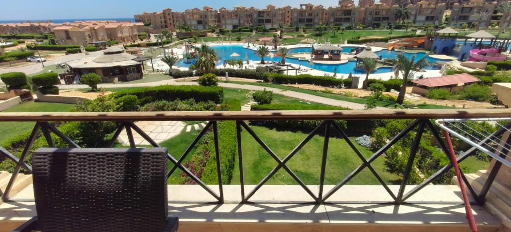 a chair sitting on a balcony with a view of a resort at Aqua View Chalet at Piacera Resort-Ain Sokhna in Ain Sokhna