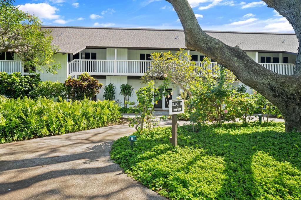 a building with a street sign in front of it at Kauai Kiahuna Plantation #104 by Coldwell Banker Island Vacations in Kipu