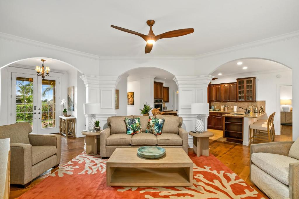 a living room with a couch and a table at Kauai Wainani Villa by Coldwell Banker Island Vacations in Koloa