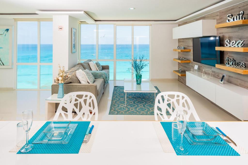 a living room with a view of the ocean at Ocean View Modern Condo & Luxury Amenities in Cancún