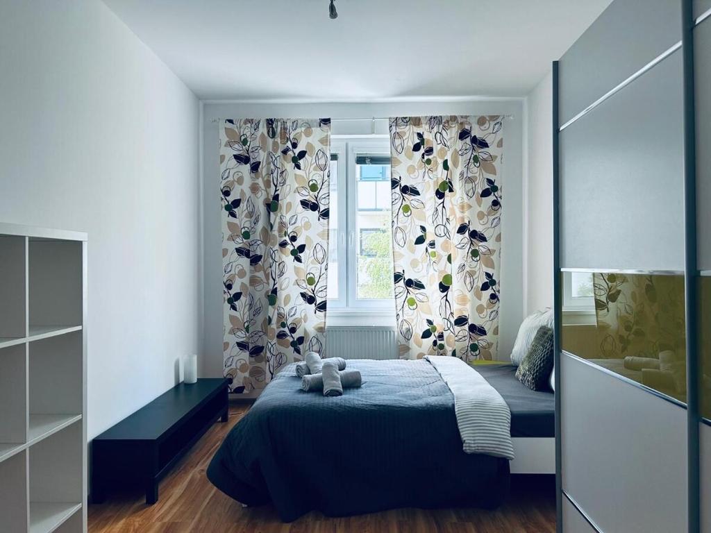 a bedroom with a blue bed and a window at Sweet Dreams - cozy Stay in city center in Bratislava