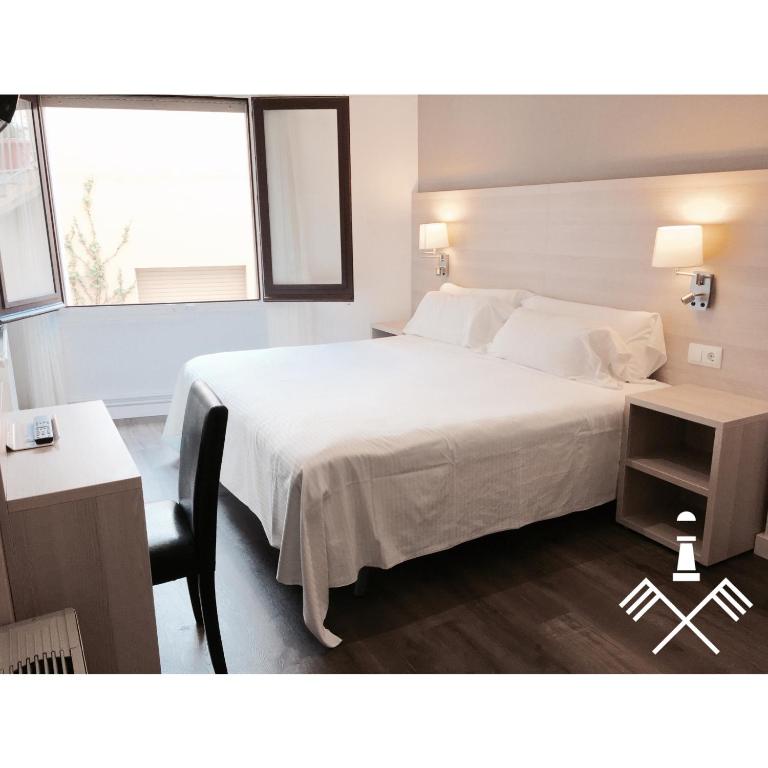 Postel nebo postele na pokoji v ubytování Hotel Carbonell
