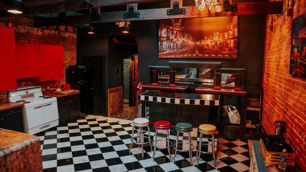 a kitchen with a black and white checkered floor at Broadway Penthouse 4br 3bth 2500 SF in Nashville