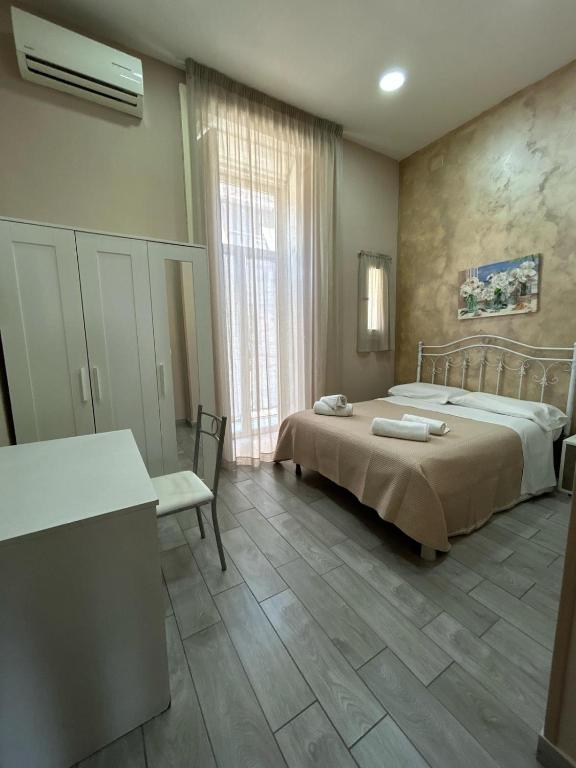 sypialnia z łóżkiem, stołem i oknem w obiekcie B&B Panorama 17 w mieście Neapol
