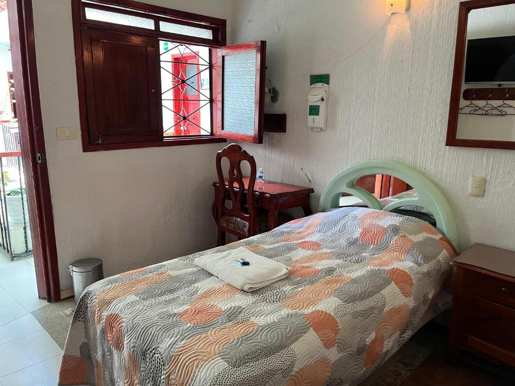 Postel nebo postele na pokoji v ubytování Hotel Las Flores