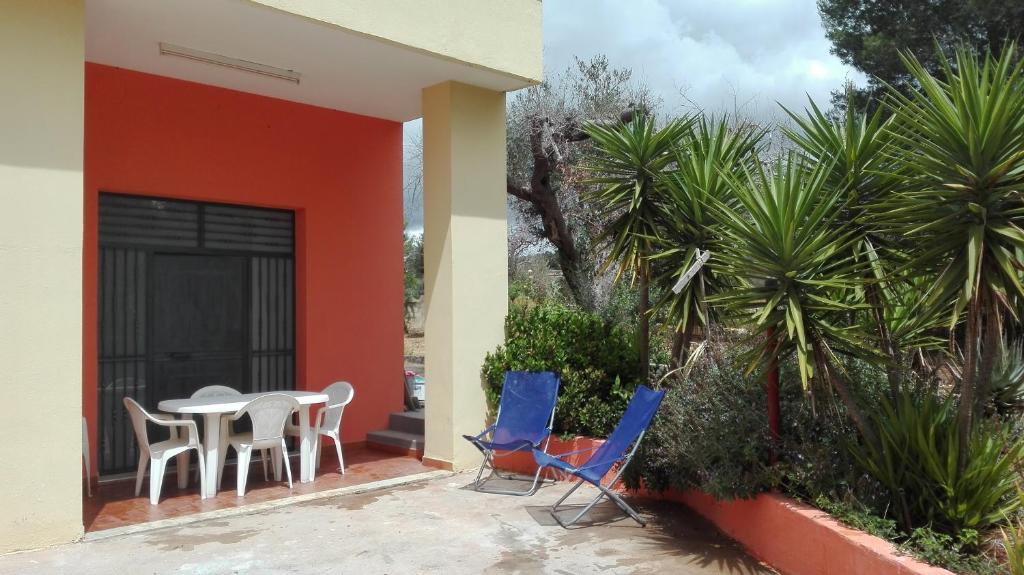 a patio with chairs and a table on the side of a house at Casa Vacanze Le Macchie in Parabita