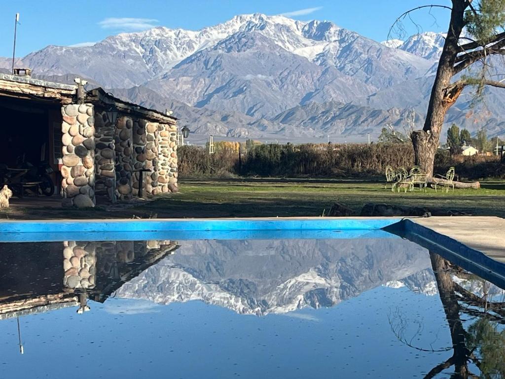 a reflection of a mountain in a pool of water at Posada La Escondida in San Carlos