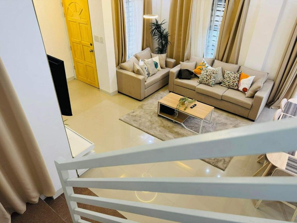 a living room with a couch and a table at 4 bedroom with big pool villa near clark in Sampong